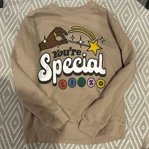 lizzy concert merch tan crewneck